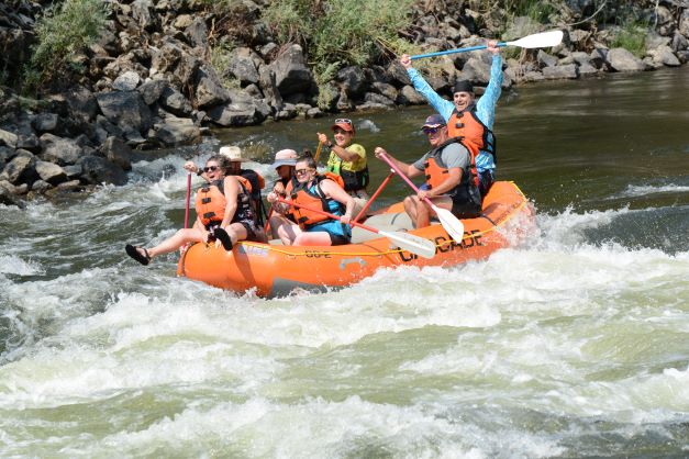 6 people in a raft floating over rapids in the Payette River in Idaho.