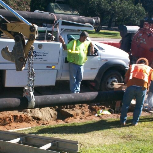construction workers installing a water pipe